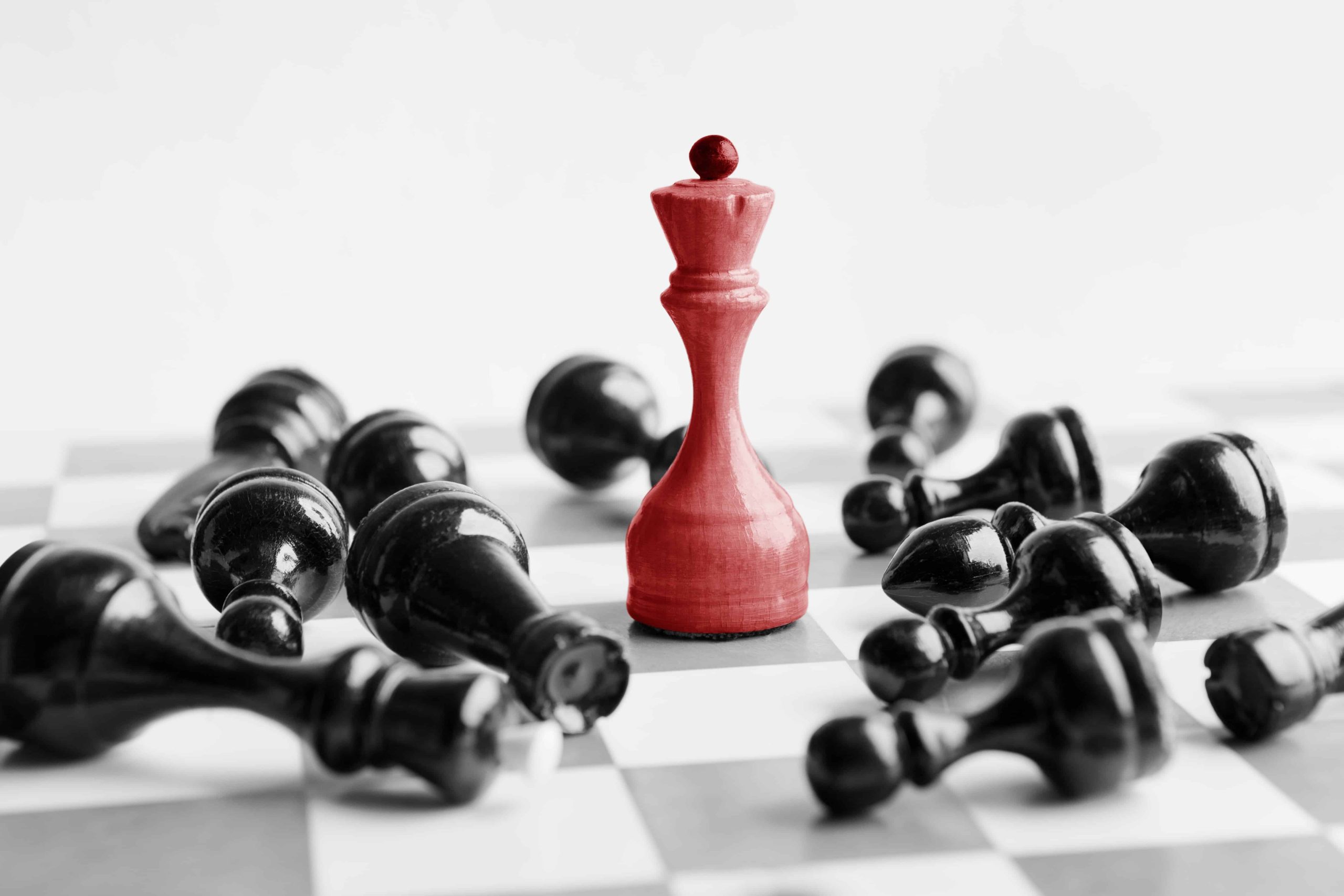 white-chess-queen-beats-blacks-on-chessboard