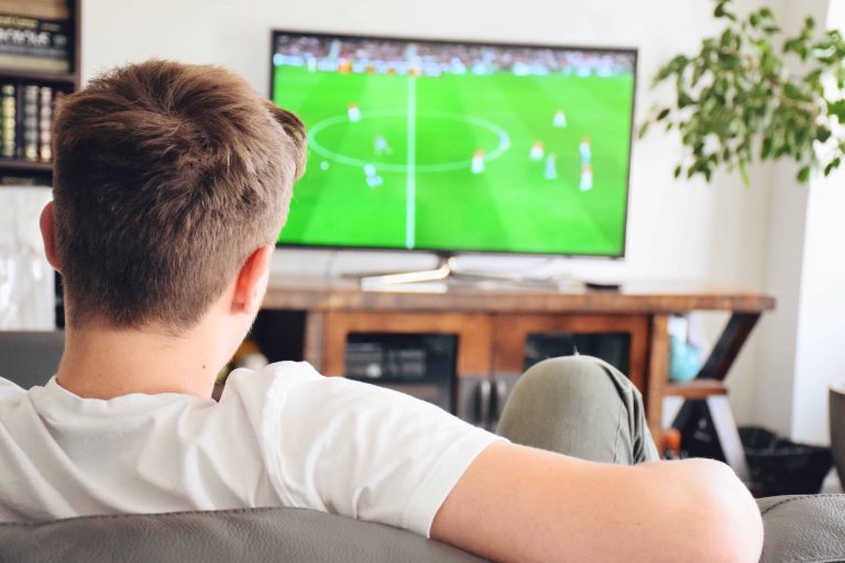 young-man-watching-soccer-game-on-tv-football-game